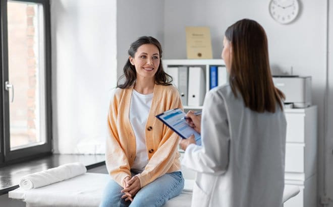 Women's specialty female doctor speaking with female patient